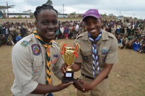 KZN Rally online- national youth representative Henry Sibande hands over award to winning Cub Pack Scouter Ntuthu Jobela credit steve camp