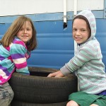 Lucy Harris and Maggie Vermaak filling a tyre garden