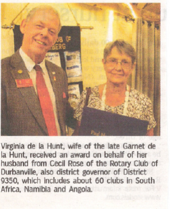 Virginia de la Hunt receives award on behalf of late husband Garnet